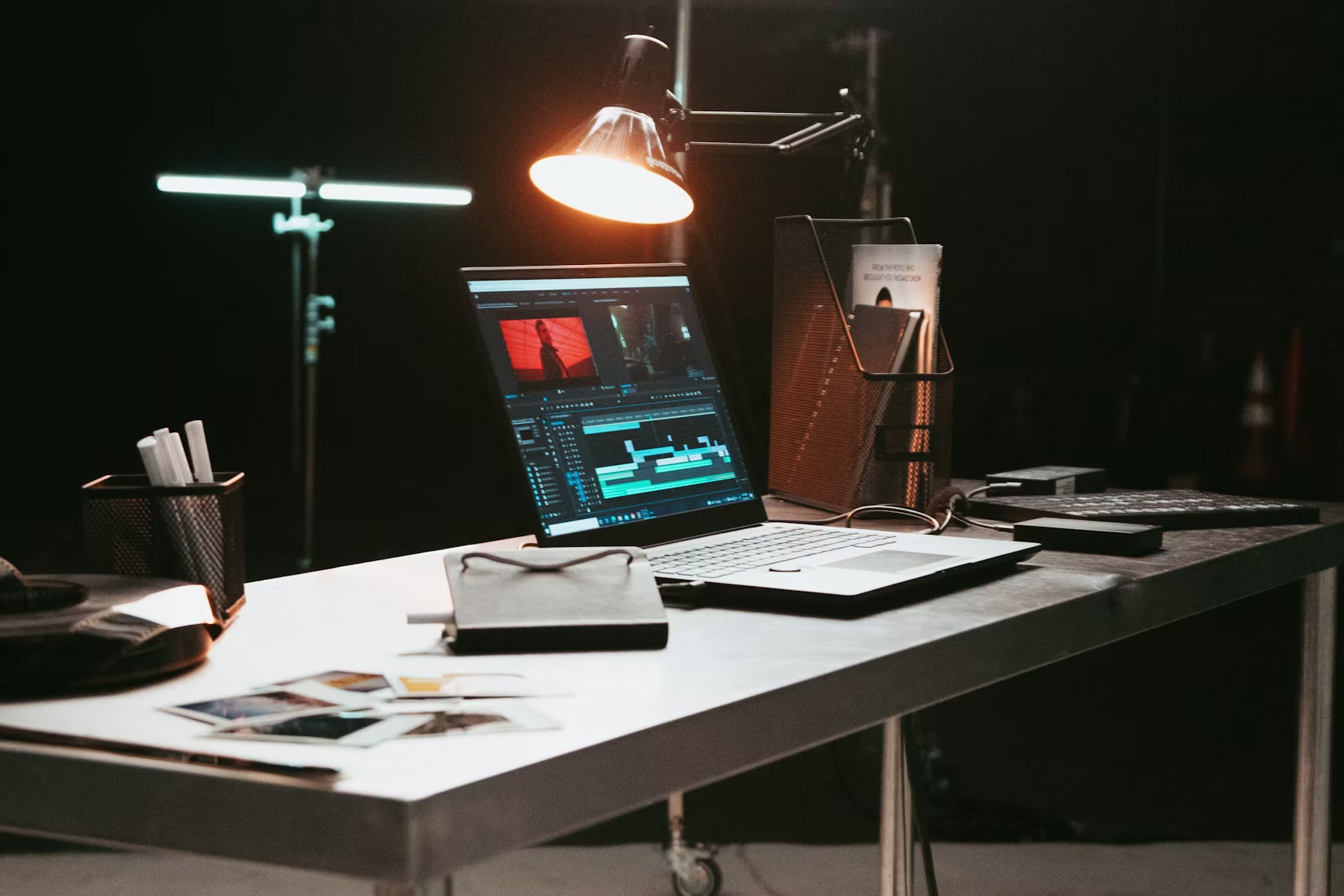 Video editing desk with a laptop showing an editing timeline
