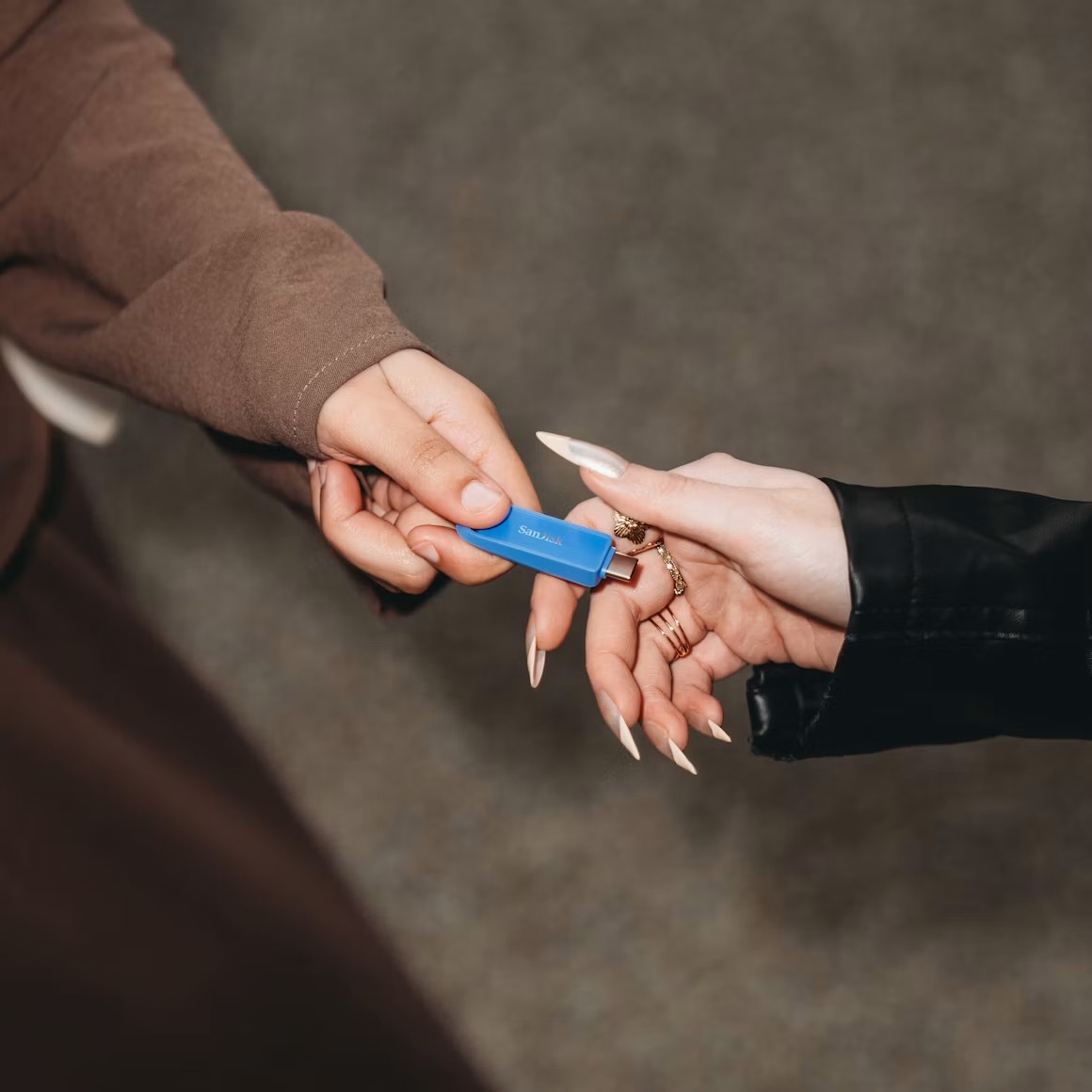 Handing over a USB drive with the finished content